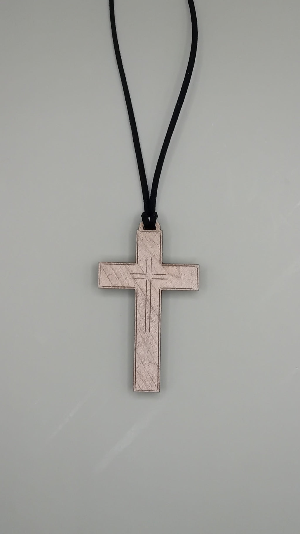 Engraved beech wood cross pendant on black faux suede cord