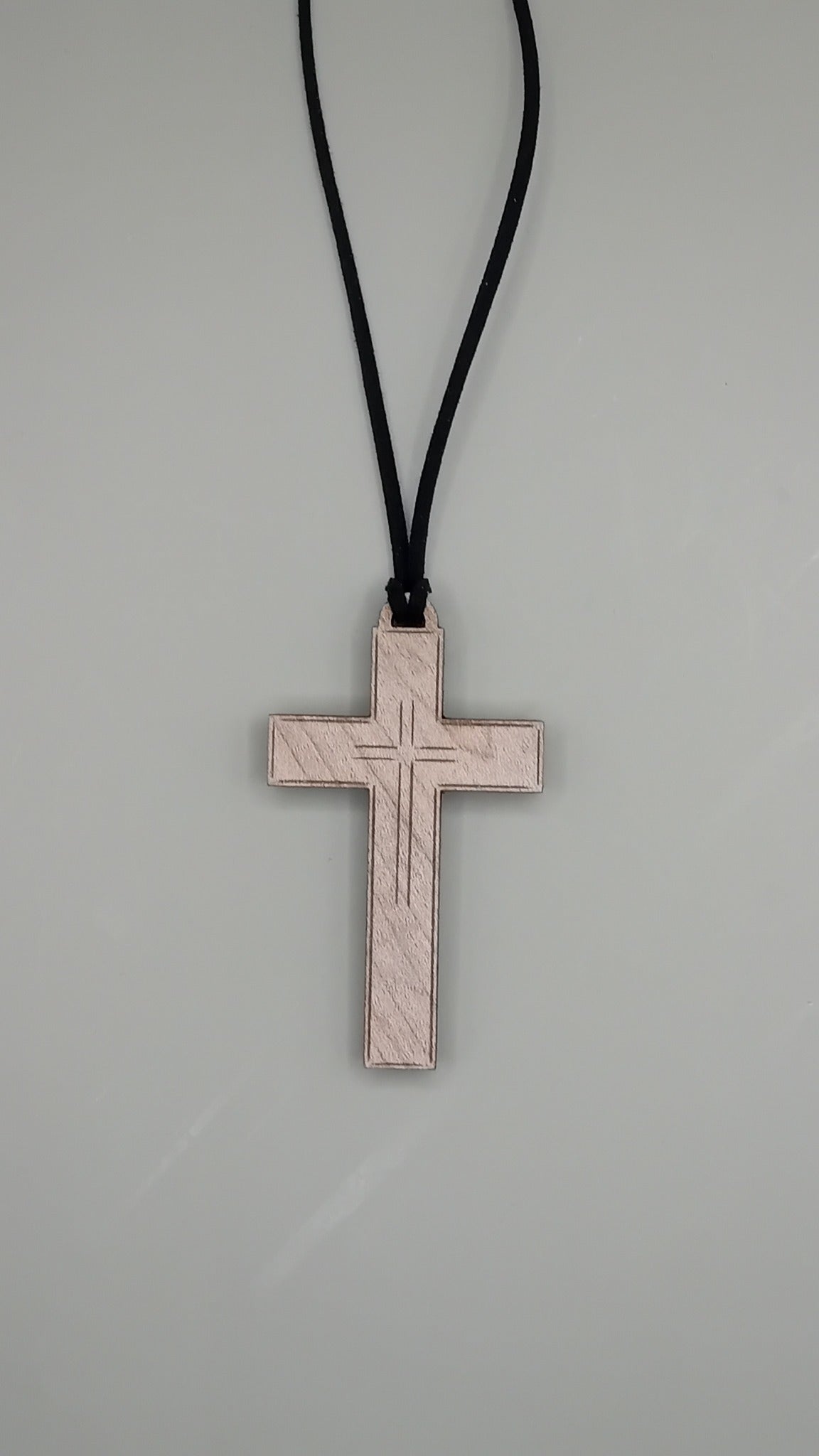 Engraved beech wood cross pendant on black faux suede cord