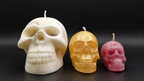 Small medium and large handmade skull candles shown together for size comparison